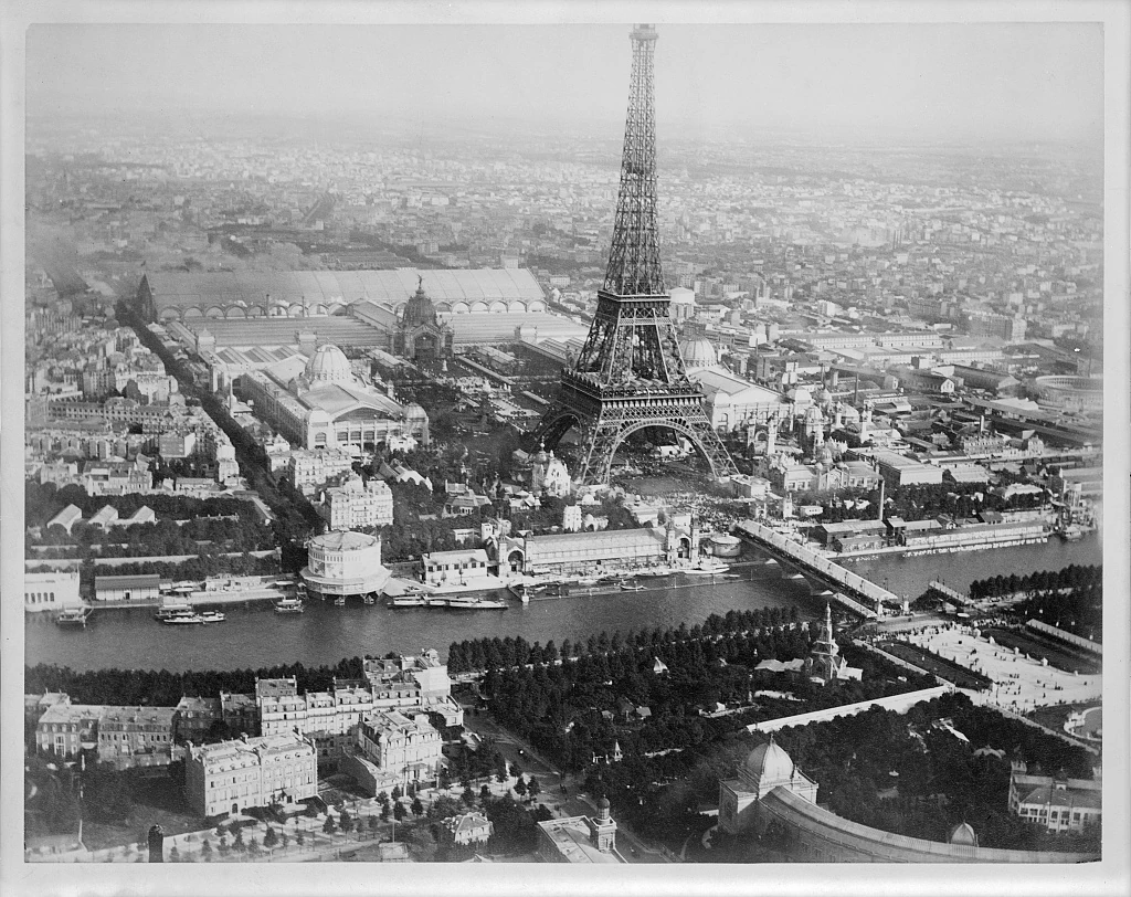 Aerial photograph of the Eiffel Tower, exhibition buildings and the Seine, seen from a balloon in 1889.