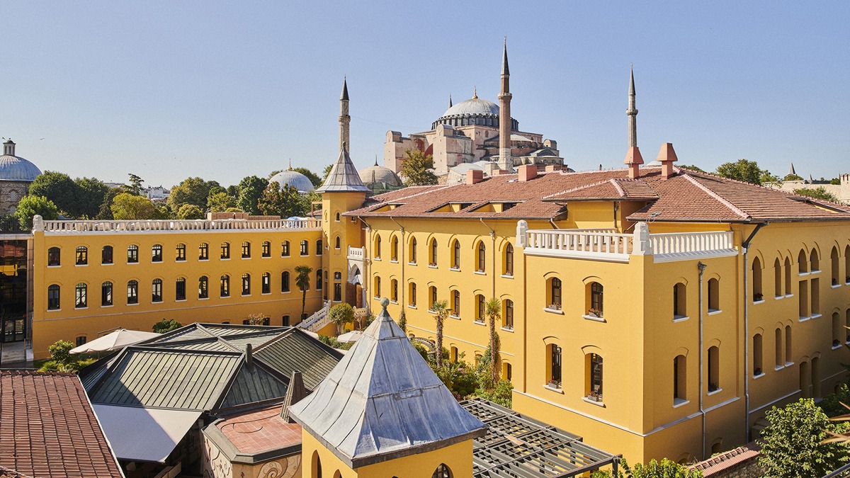 Yellow façades and tiled roofs of Four Seasons Hotel Istanbul at Sultanahmet, with Hagia Sophia behind. Photograph: Four Seasons.