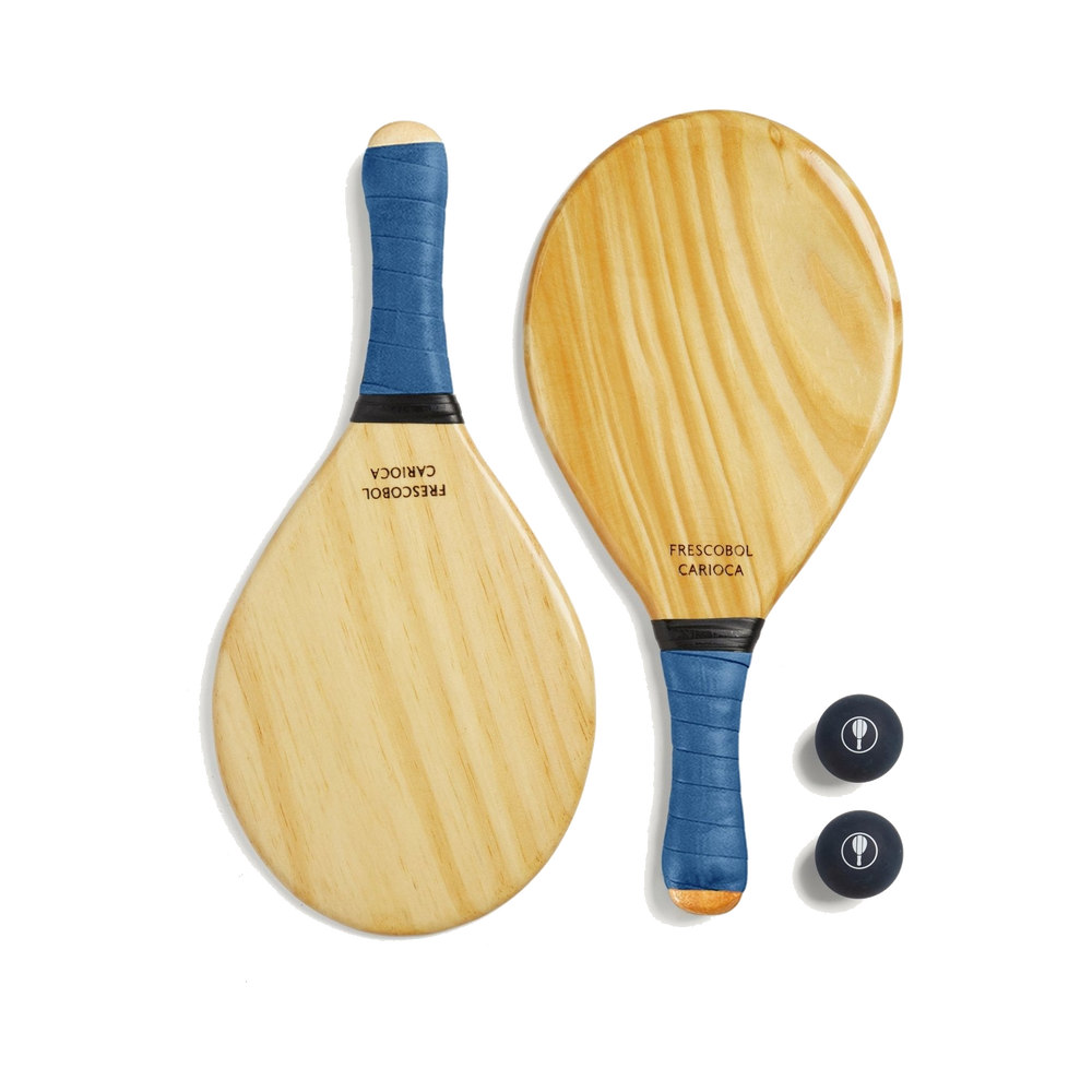Two Frescobol Carioca pine beach bats with blue grips and two navy balls.