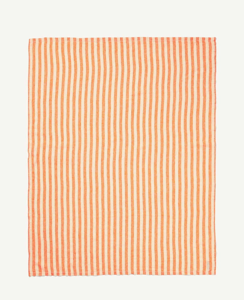Orange-and-off-white striped linen towel laid flat, showing its full rectangular shape.