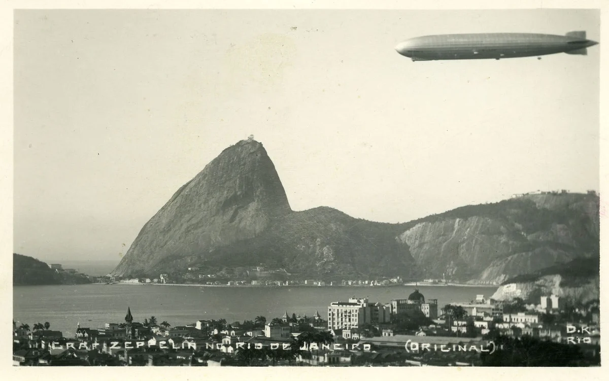 Graf Zeppelin flying above Rio de Janeiro and Guanabara Bay, with Sugarloaf Mountain beneath the airship.