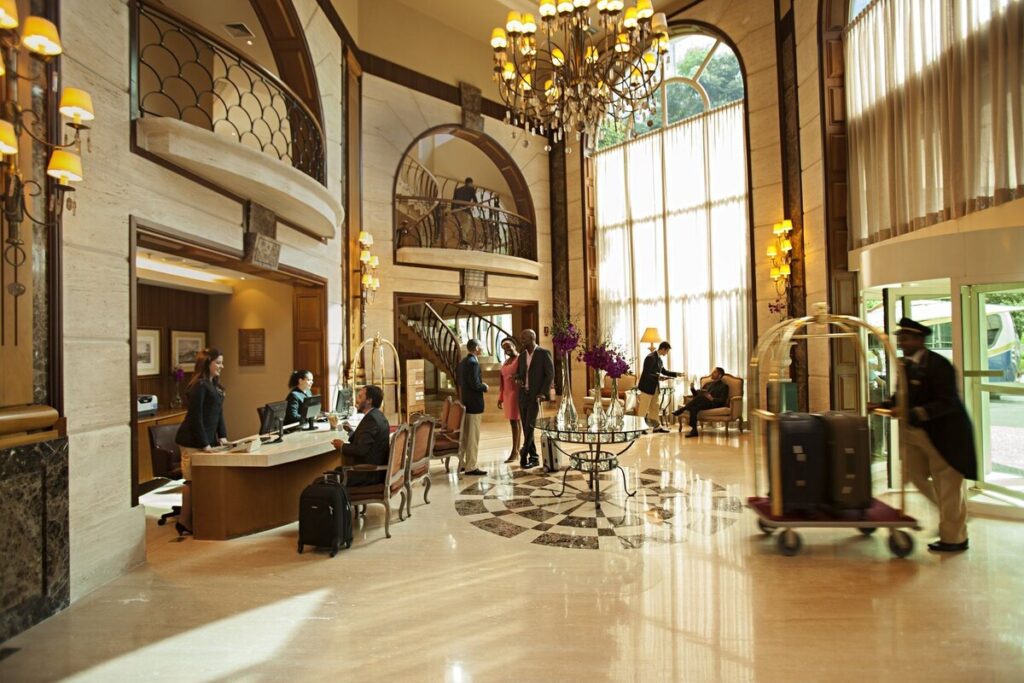 The double-height lobby of Gran Estanplaza Berrini, with a crystal chandelier, curved balconies and the reception desk.
