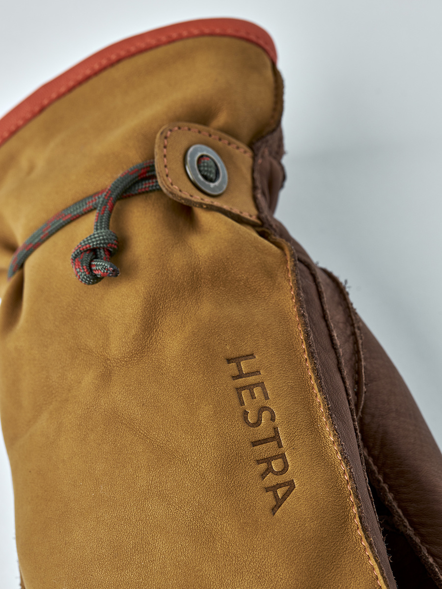 Hestra lettering and cord wrist adjustment on a cork-coloured leather mitten.