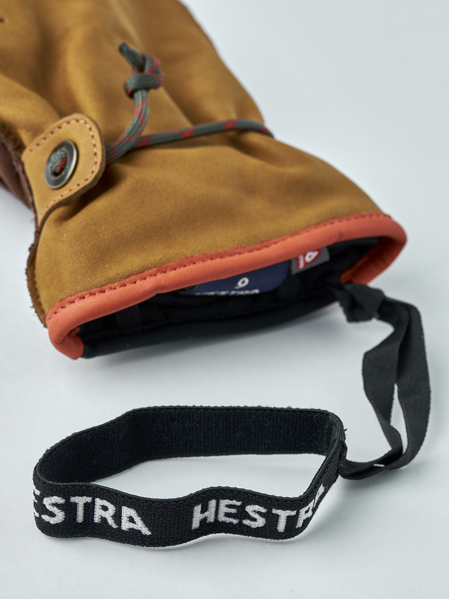 Orange-trimmed Wakayama mitten cuff and its black Hestra wrist strap.