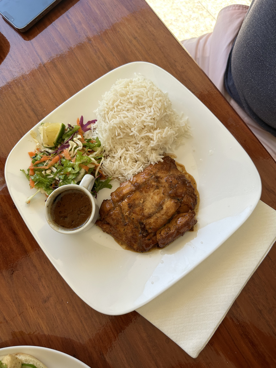 A plate of fish with rice, salad and sauce at Le Chevalier Bay.