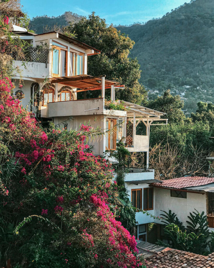 White suites rising above tiled roofs and bougainvillea at Lush Atitlán