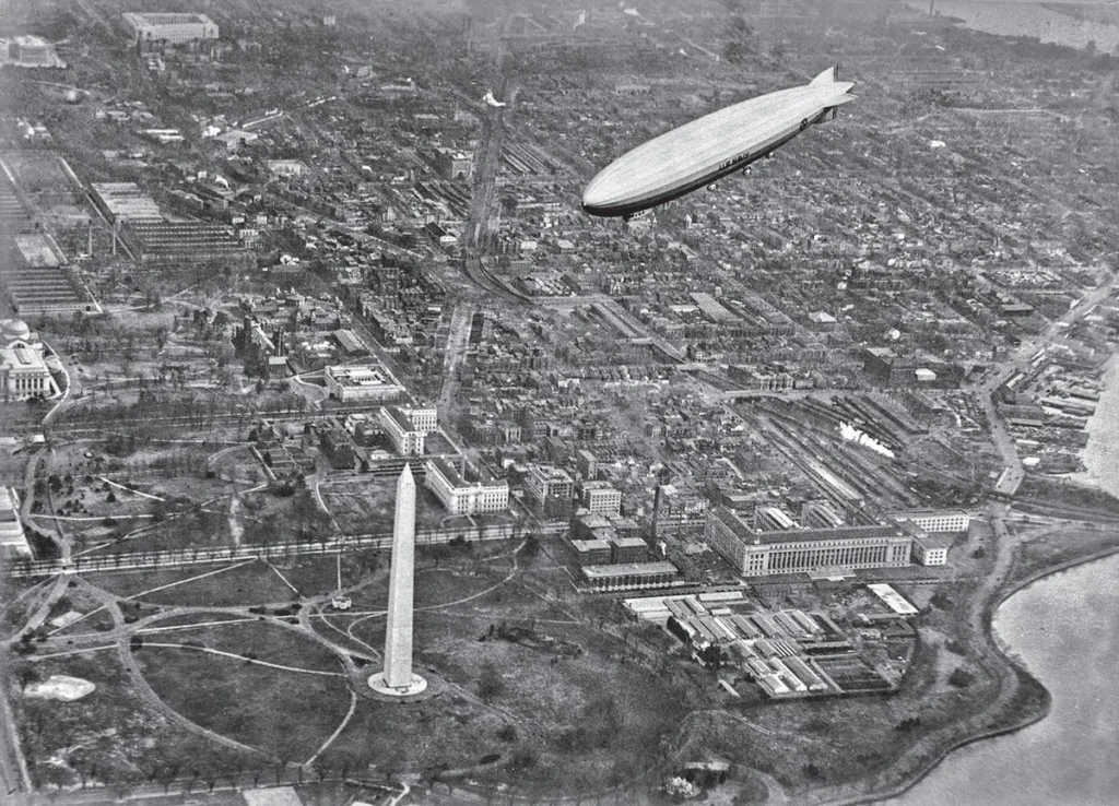 LZ 126 flying above Washington, D.C., with the Washington Monument, government buildings and the Potomac below.