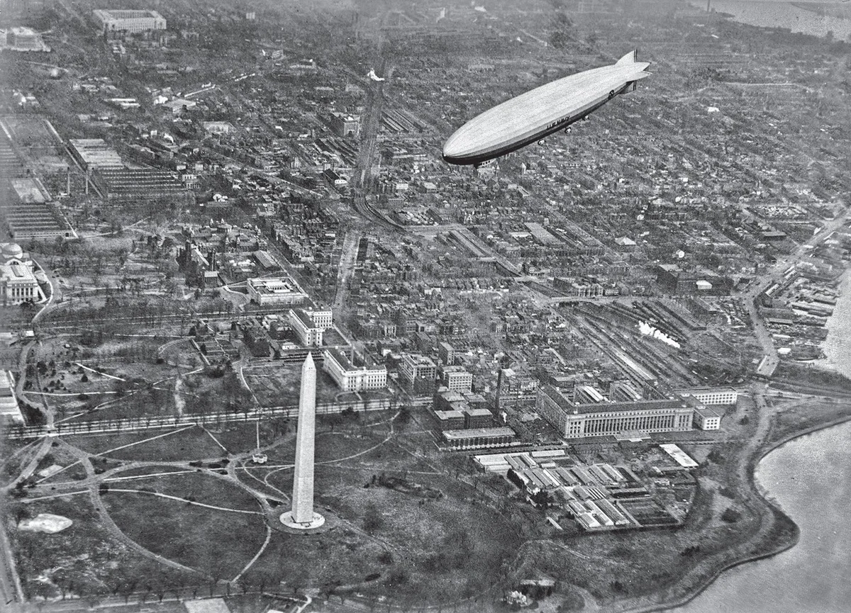 LZ 126 flying above Washington, D.C., with the Washington Monument, government buildings and the Potomac below.