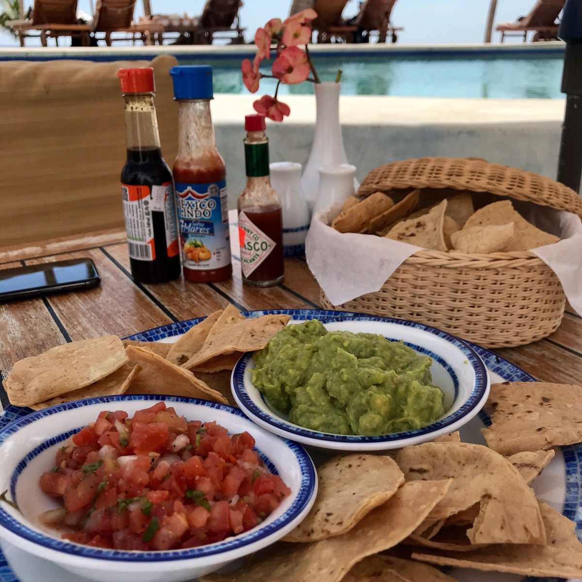 Guacamole, salsa and tortilla chips served beside the pool.