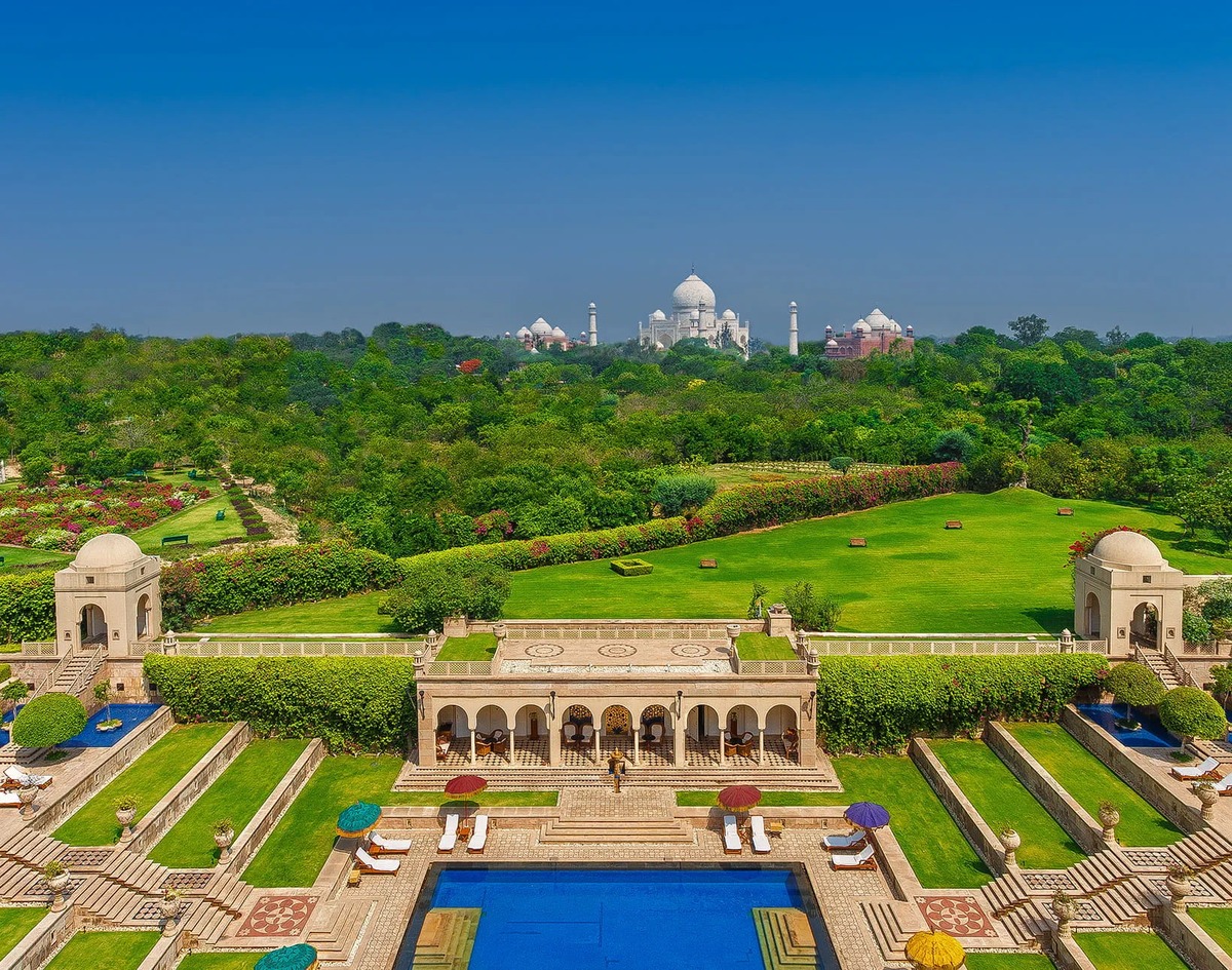 Terraced gardens and swimming pool at The Oberoi Amarvilas, with the Taj Mahal beyond. Photograph: Oberoi Hotels & Resorts.