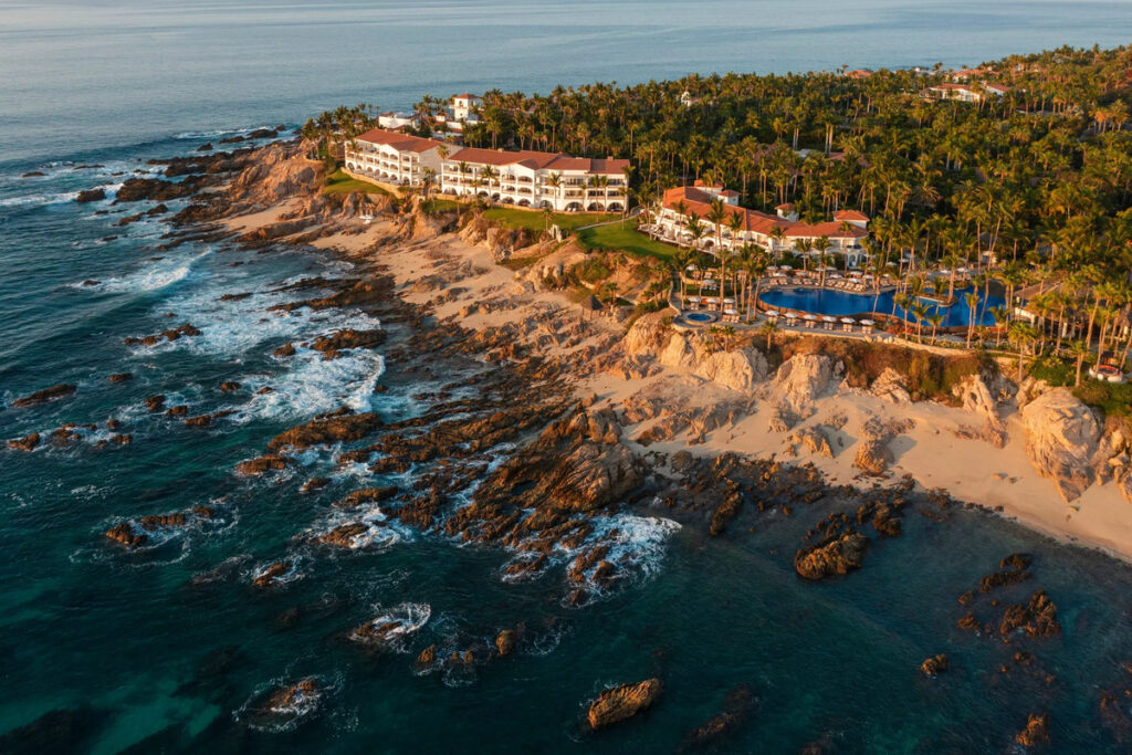 Aerial view of One&Only Palmilla’s buildings, pools and rocky shoreline.