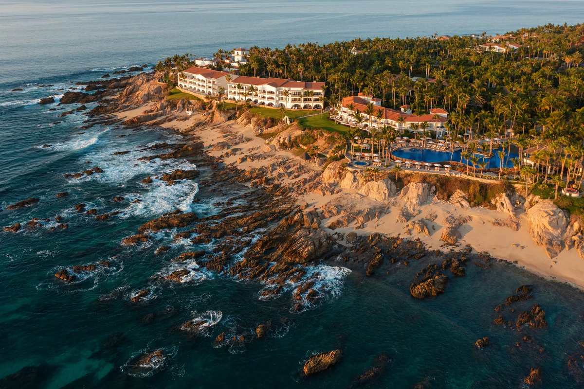 Aerial view of One&Only Palmilla’s buildings, pools and rocky shoreline.