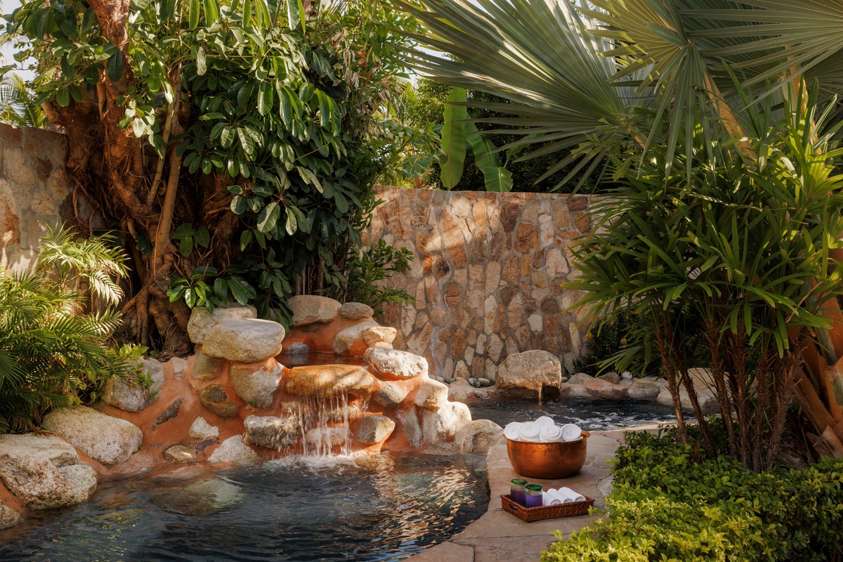 Small spa pools surrounded by tropical foliage and stone walls at One&Only Palmilla.