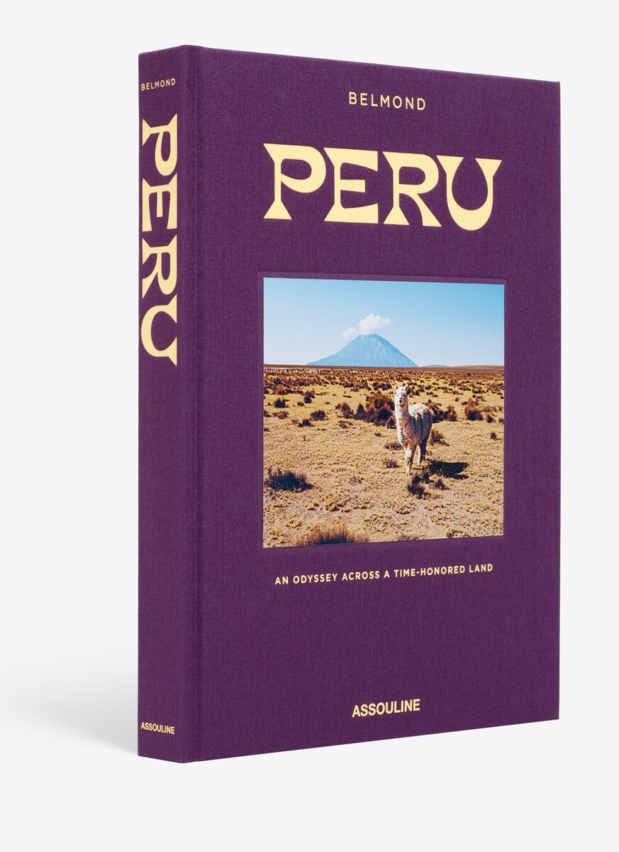 The purple Peru hardcover by Assouline and Belmond, with gold lettering and a cover photograph of an alpaca below a volcano.