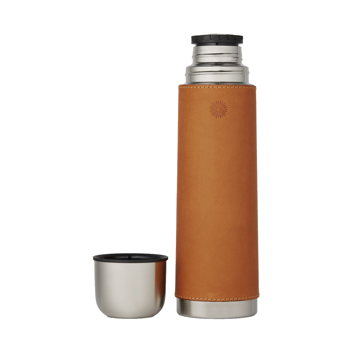 Tan leather Purdey flask with its steel cup-cap standing beside it.