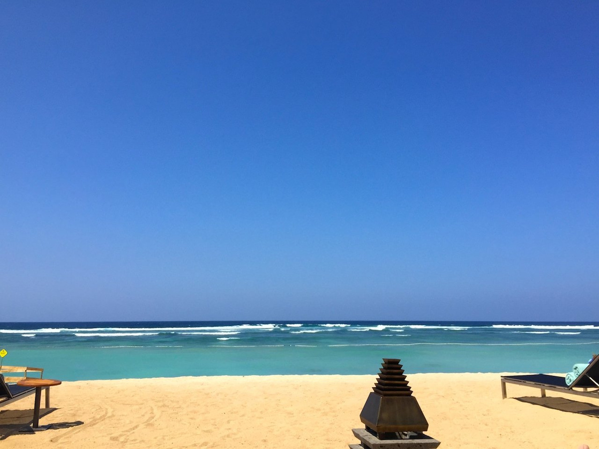 Sun loungers beside the pale sand and turquoise sea at The Ritz-Carlton, Bali