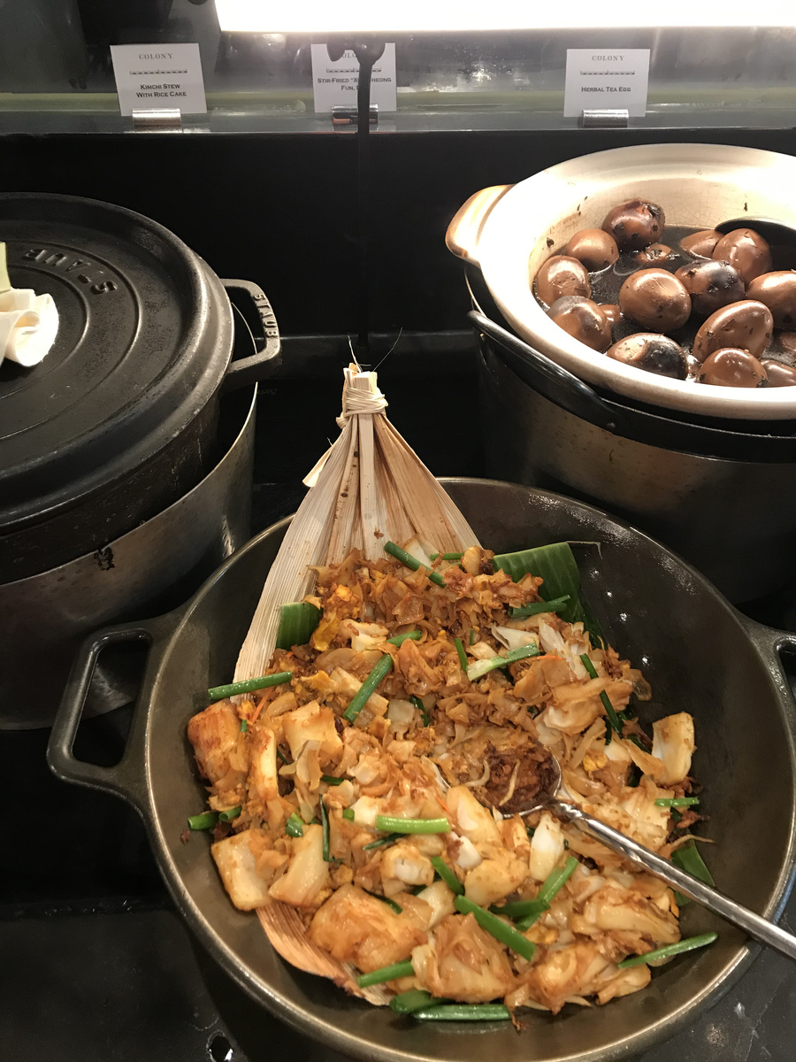 Herbal tea eggs and stir-fried rice rolls displayed at the Colony buffet