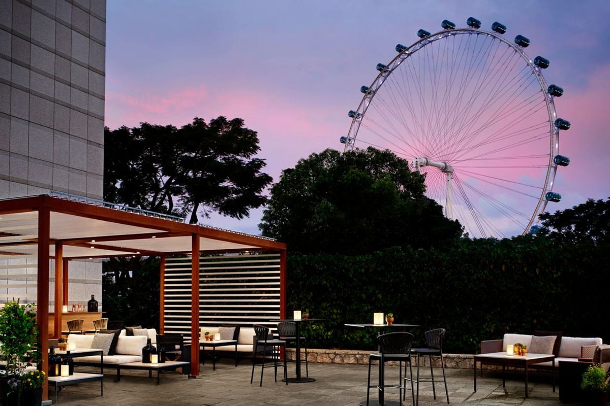 Outdoor seating on the Republic terrace beneath the Singapore Flyer at dusk
