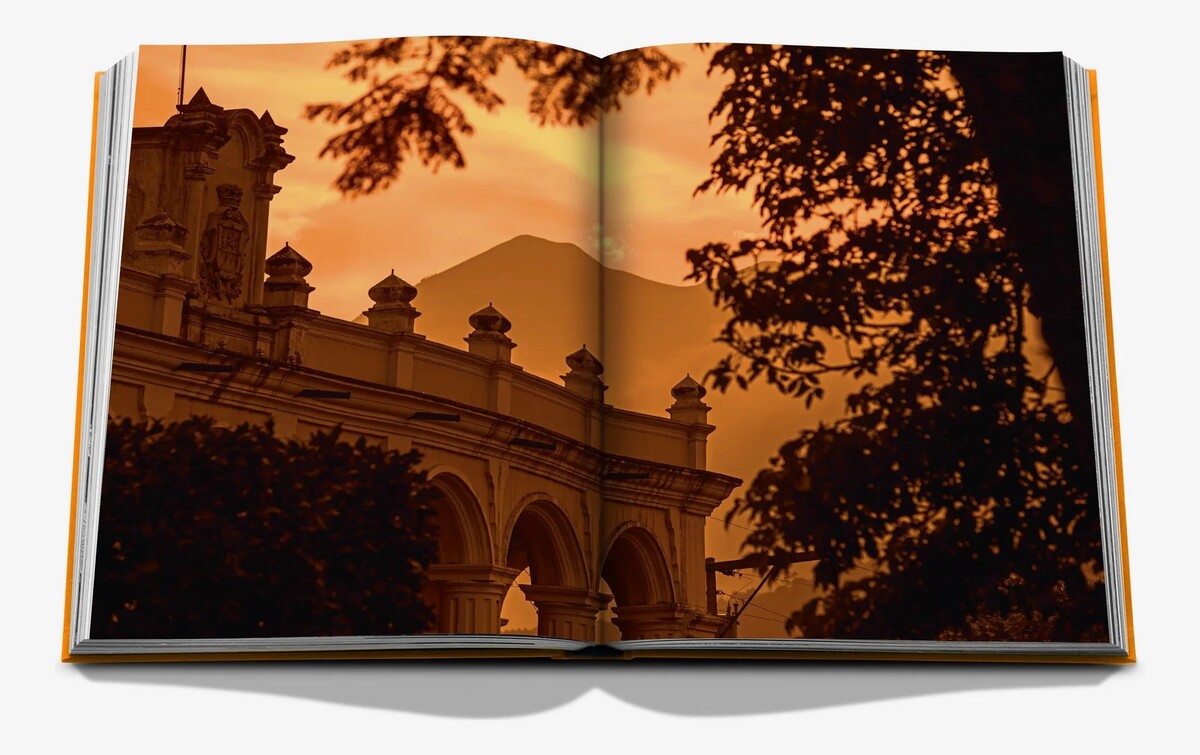 An open spread showing an arched colonial building and a volcano silhouetted against a golden sunset.