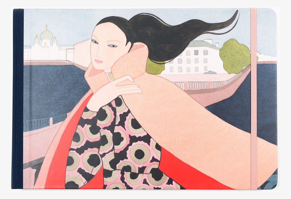The illustrated Saint Petersburg Travel Book cover, with a woman beside a river, a navy cloth spine and a pink elastic band.