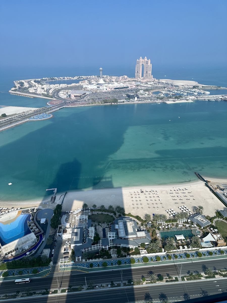 The Corniche, beachfront and Al Kasir Island seen from a high hotel window.