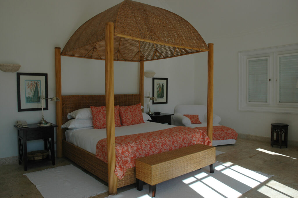 Woven canopy bed with coral-patterned bedding in a Tortuga Bay bedroom in 2007.