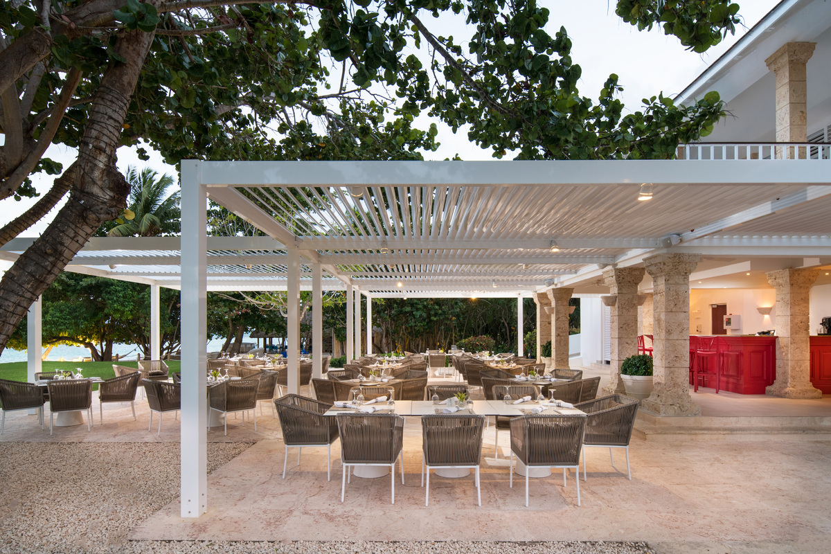 Shaded restaurant terrace overlooking the seafront at La Cana.