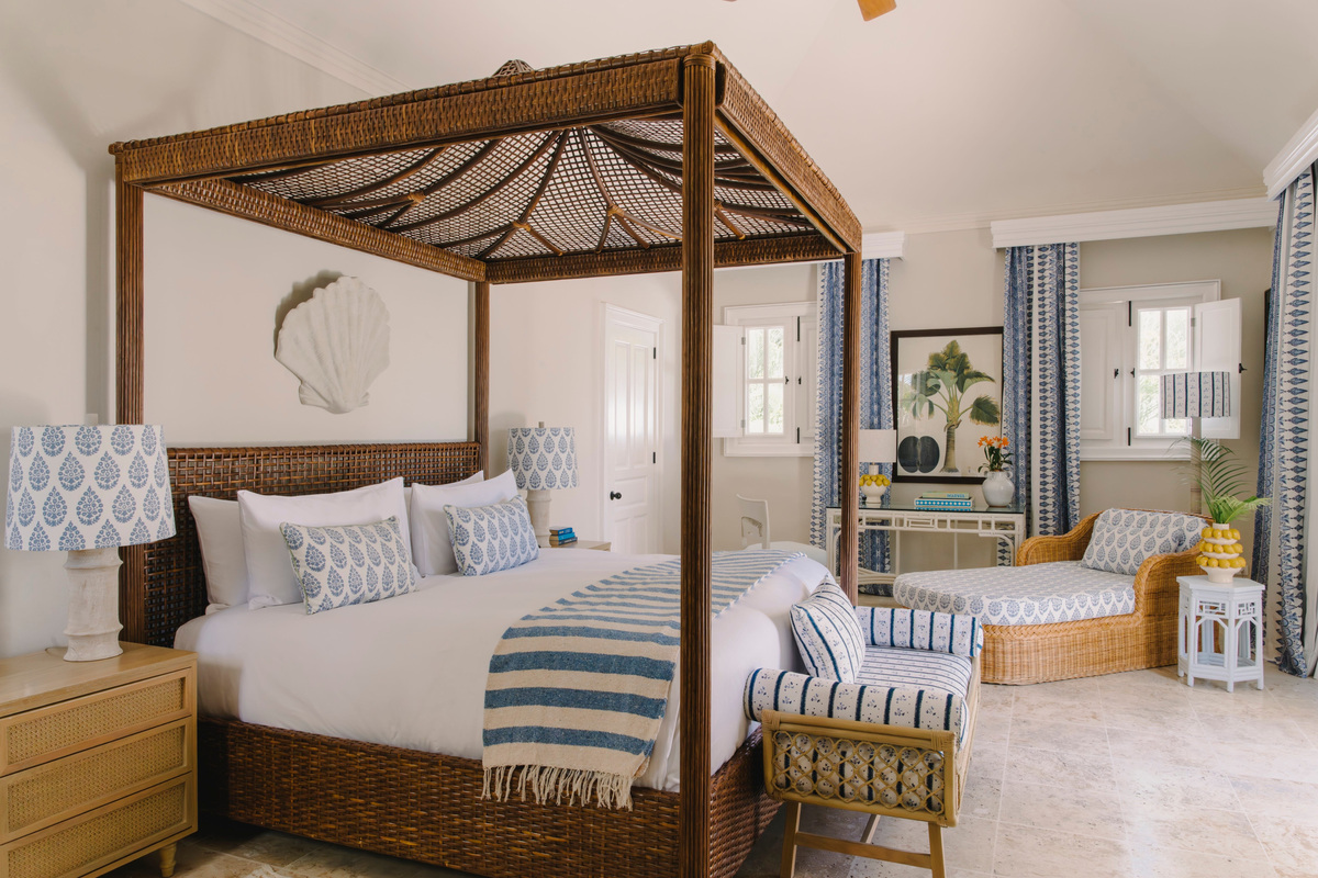Woven canopy bed and blue-and-white textiles in a refreshed Tortuga Bay bedroom.