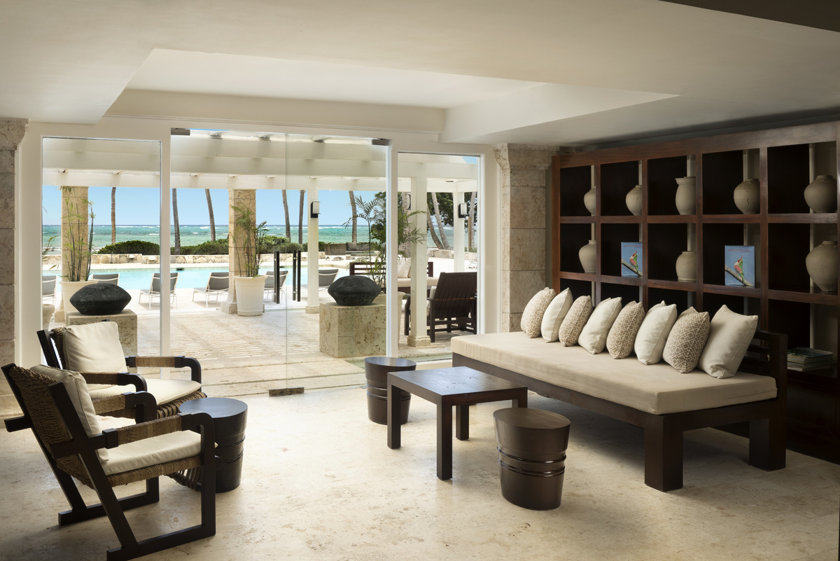 Quiet lounge seating and open doors towards the sea at the spa.