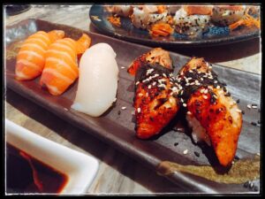 Sushi, nigiri and glazed pieces on a rectangular plate at Shibuya Ichiban.