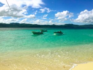 Small boats float in clear shallow water near Punta Rucia.