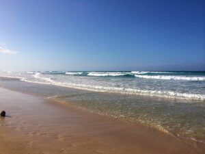 Waves roll towards the sandy shore at Playa Macao.
