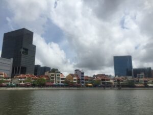 Historic quayside buildings and modern towers beside the Singapore River.