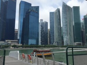 A riverboat passes Singapore’s office towers.