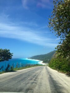 The road descends towards the blue sea at San Rafael.
