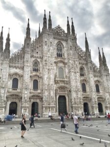 The Gothic façade of Milan Cathedral seen from the square.