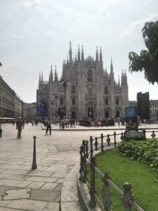 Milan Cathedral beyond the square and its flower beds.