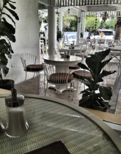 White tables and chairs on Dalia’s café terrace.