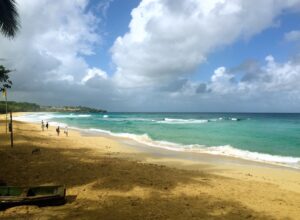 Waves break along Playa Grande beneath a cloud-filled sky.