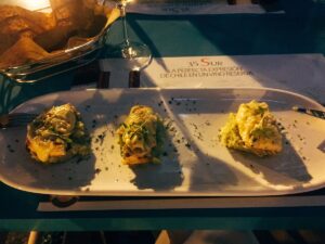 Three small starters on a rectangular plate at Noah Restaurant.