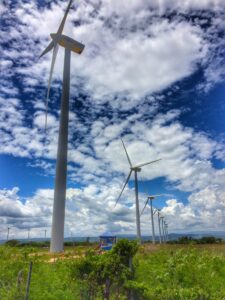 White wind turbines stand in green fields at Los Cocos.