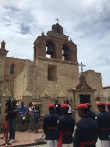 Visitors outside the limestone cathedral in Santo Domingo.