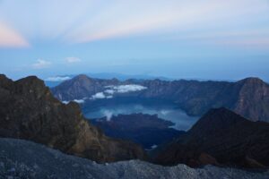 The crater lake beneath the rocky ridges of Mount Rinjani.