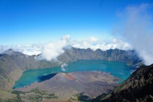 Turquoise crater water and volcanic cones seen from Rinjani’s rim.