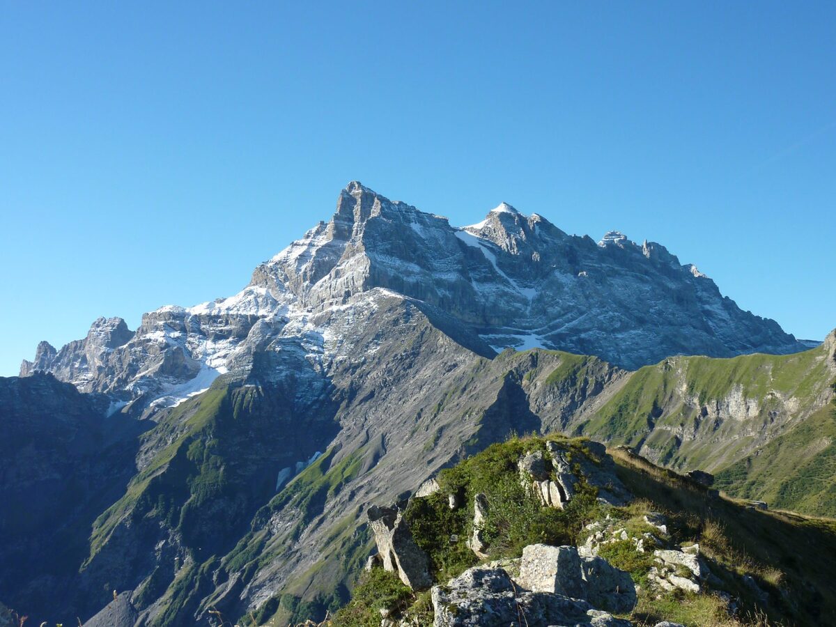 Rocky alpine peaks and green slopes seen from Valerette.