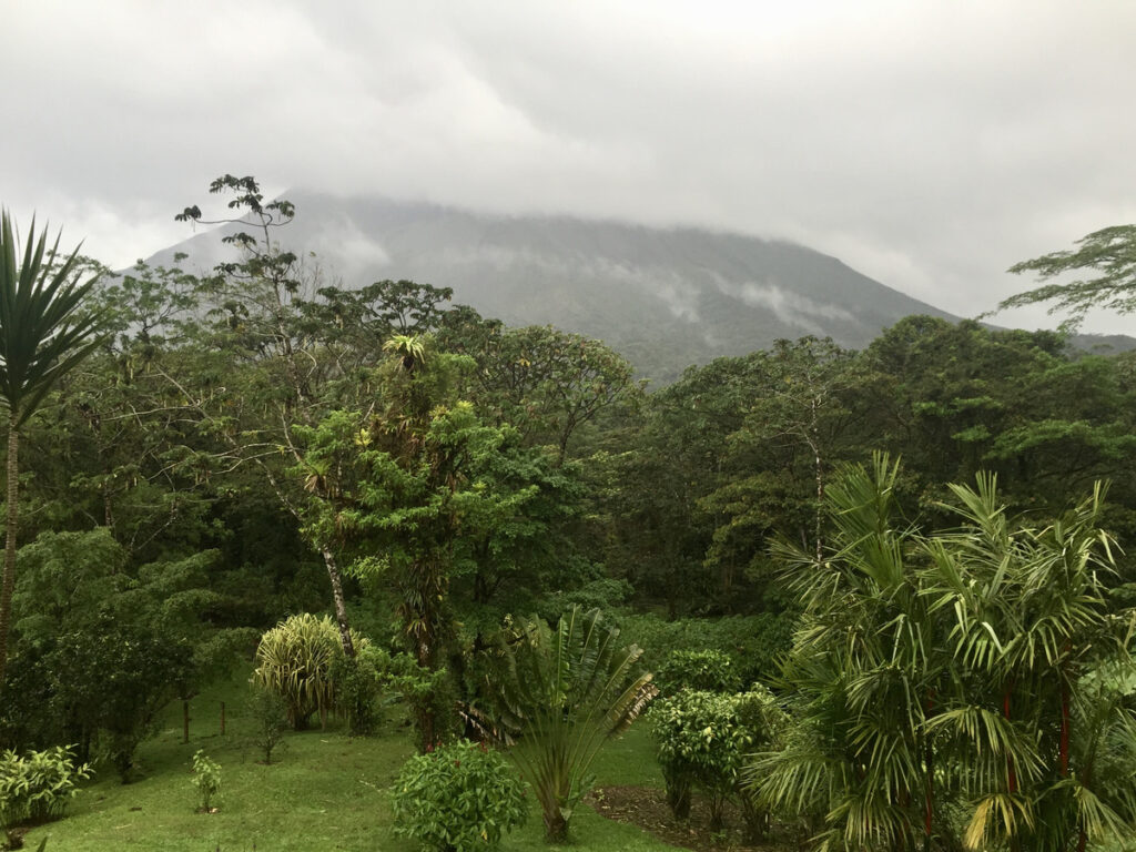 Arenal Volcano partly hidden by low cloud above the lodge’s gardens.