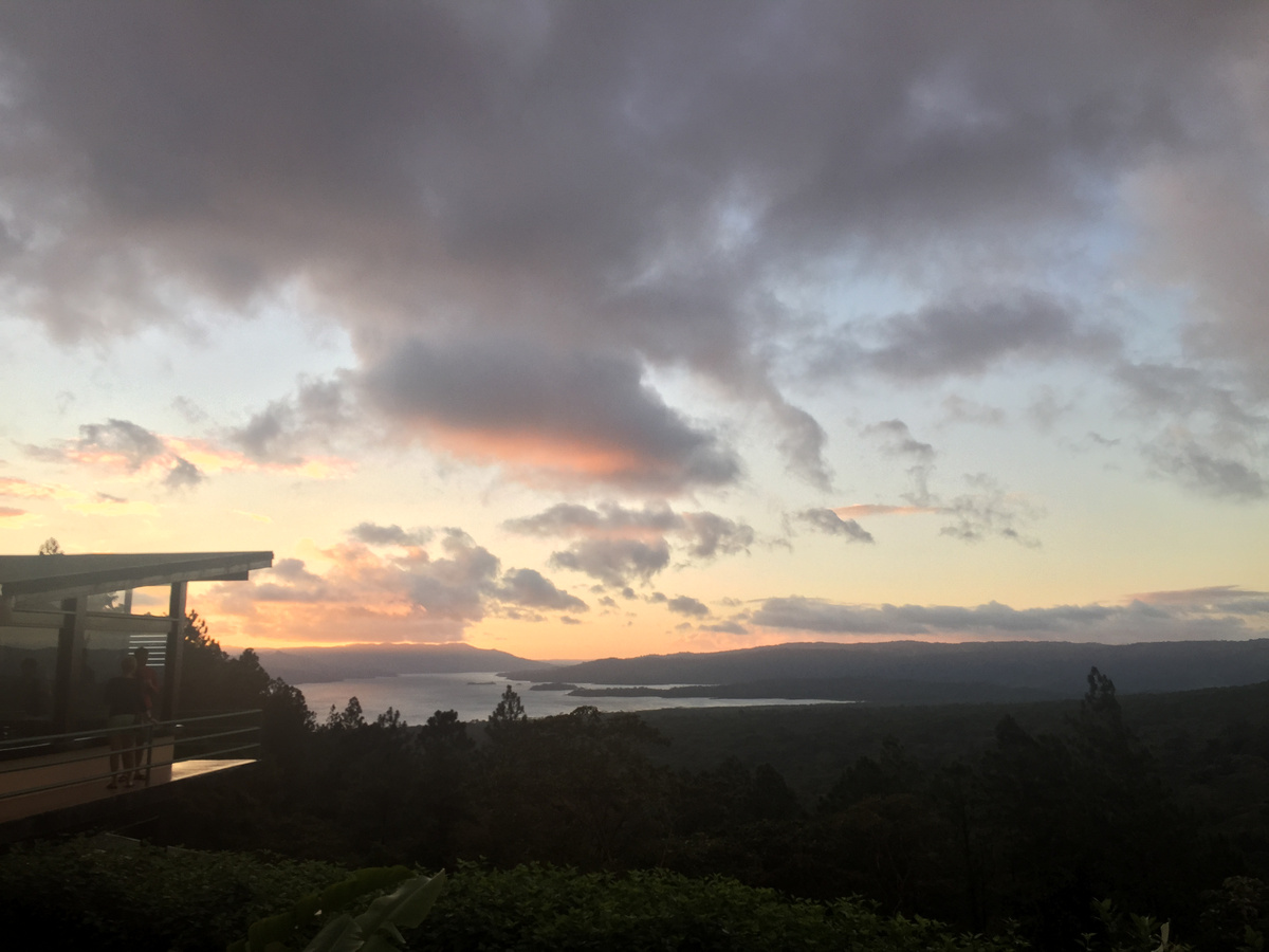 Sunset over Lake Arenal, with the lodge’s viewing deck at the left.