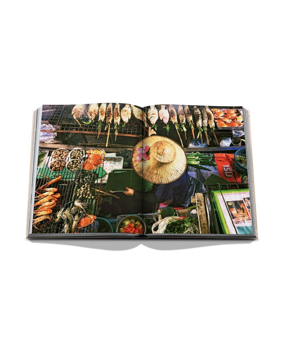 An open spread from Bangkok Spirit: a market vendor in a conical straw hat, seen from above among grills of fish, shrimp and fresh herbs.