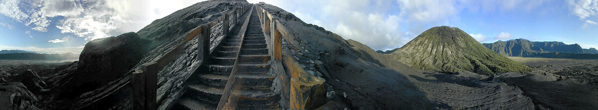 A 360-degree panorama from the stairway to Bromo’s crater rim: the concrete steps rising up the ash slope, the green cone of Batok, the Sea of Sand and the Tengger caldera wall.