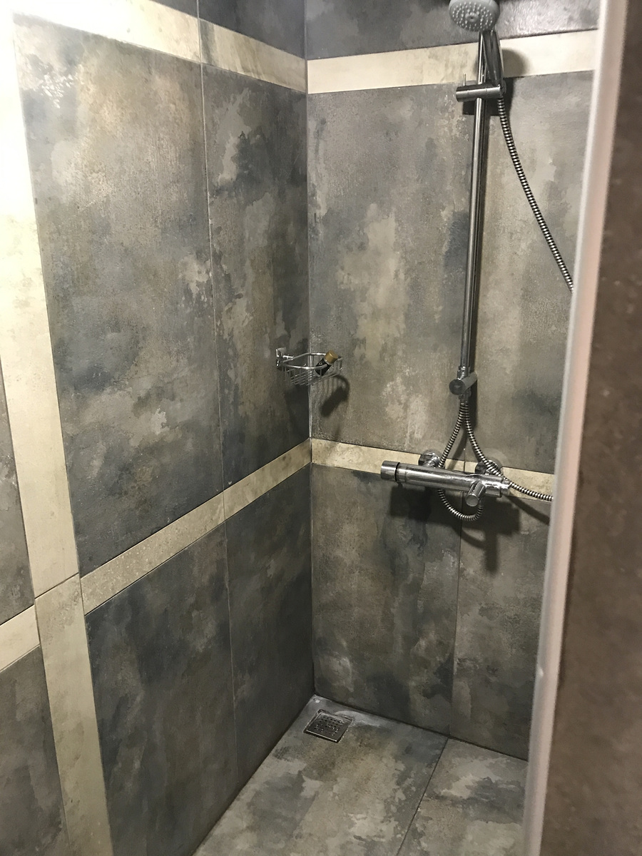 The shower and grey tiled walls in our Char Me bathroom.